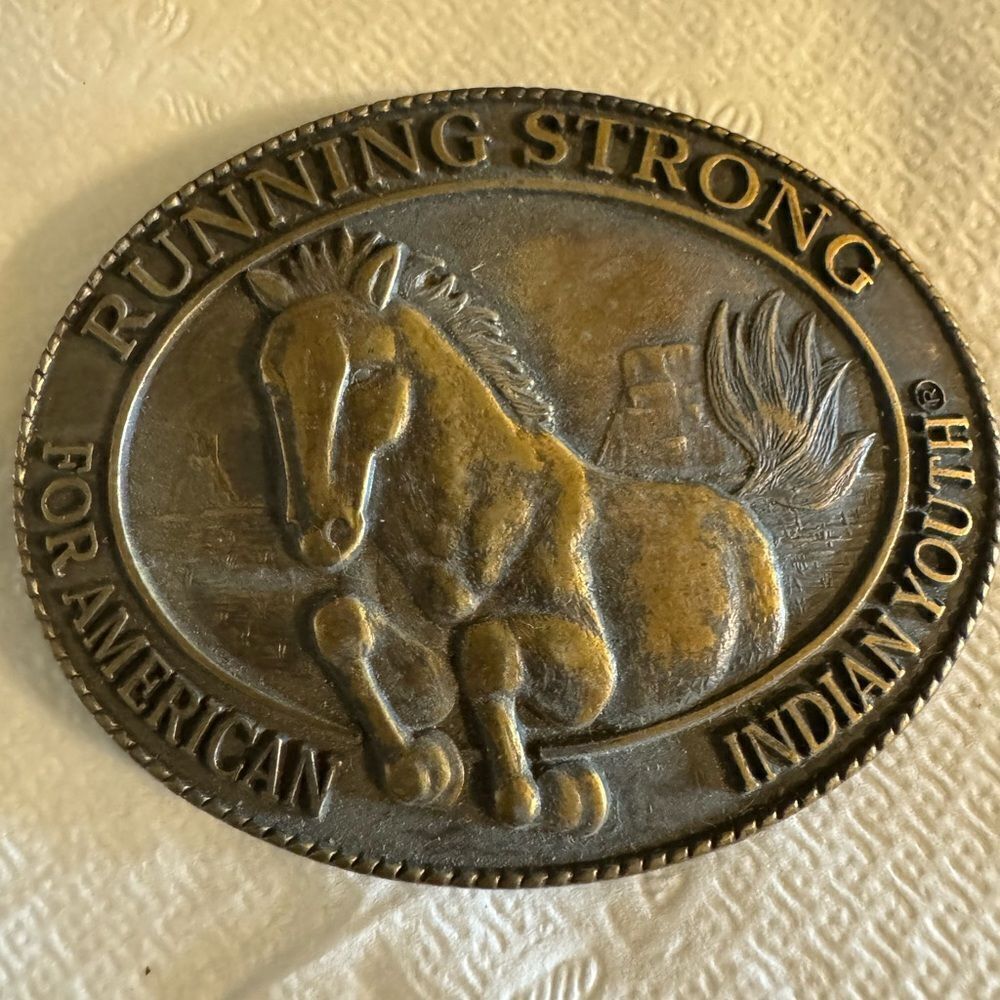 "RUNNING STRONG FOR AMERICAN INDIAN YOUTH®." BRASS BELT BUCKLE